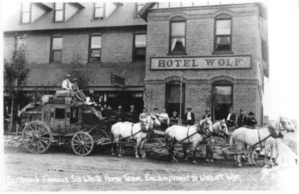 Scribner's famous six white horse team on the Encampment-to-Walcott stage, in front of the Hotel Wolf, Saratoga, around 1900. Wyoming State Archives photo.