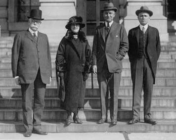 Gov. Nellie T. Ross about the time of her inauguration, with three former Wyoming governors, l. to r.: U.S. Sen. F.E. Warren, former Gov. Robert Carey, and Sen. John B. Kendrick. American Heritage Center.