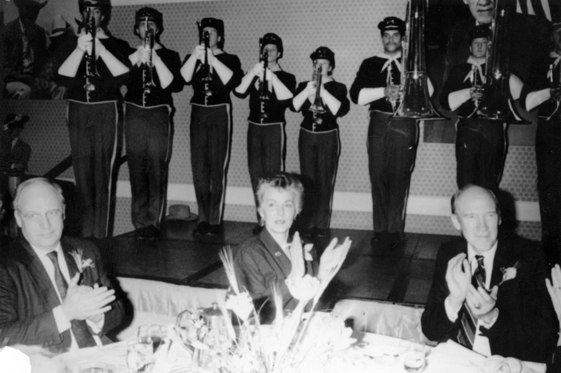 The Troopers performed for a dinner honoring Wyoming’s U.S. Senator Alan Simpson, right, when he received the "Citizen of the West Award" in Denver, Jan. 8, 1990. U.S. Defense Secretary and former Casperite Dick Cheney, left, emceed; Ann Simpson is at center. The Troopers from left to right are Mike Ottoes, Scott Reinsbach, Robert Schlichting, Cedro Toro, Jennifer Williams, Jim Brown, and Jeff Hoyt. Troopers Archives #1880.