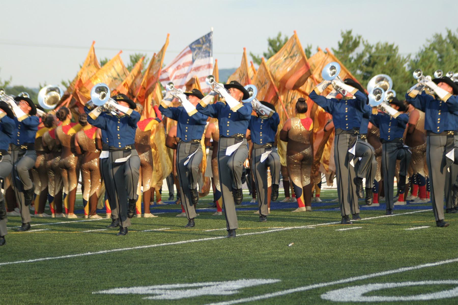 The Troopers march in a “Sunburst” formation with a U.S. flag rising from the center at a late afternoon performance, at the DCI Eastern Classic in Allentown, Pennsylvania, August 2, 2013. Pat Chagnon photo. Troopers Archives #9068.