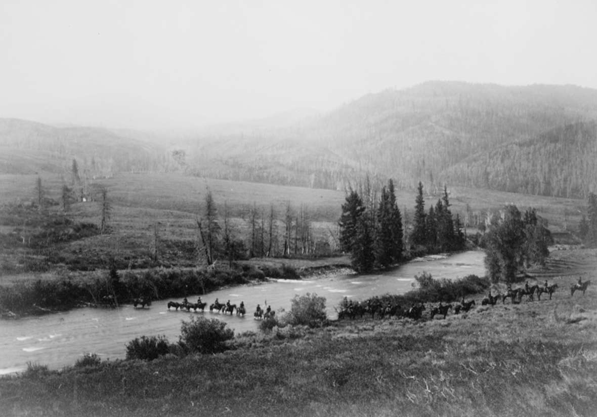 An escort of 75 soldiers and 175 pack animals accompanied the presidential party. From the headwaters of Wind River, they crossed the Continental Divide at Sheridan Pass, about 10 millers south of Togowotee Pass where the highway crosses today. From there they continued west down the Gros Ventre River to Jackson Hole. Here, the escort crosses the Gros Ventre.  F. Jay Haynes photo, Library of Congress.