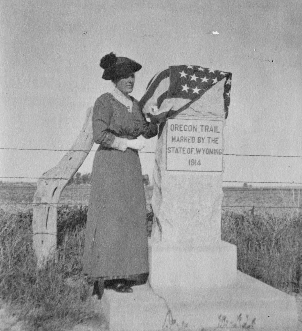 By 1911, Daughters of American Revolution chapters in Wyoming had begun marking historic trails. University of Wyoming professor and D.A.R. State Regent Grace Raymond Hebard lobbied heavily for a state-D.A.R partnership. In 1913, the legislature established a three-member Oregon Trail Commission with a budget of $2,500. Hebard joined the commission in 1914. Here she dedicates a marker on the trail just west of Torrington, Wyo., June 17, 1915. American Heritage Center.