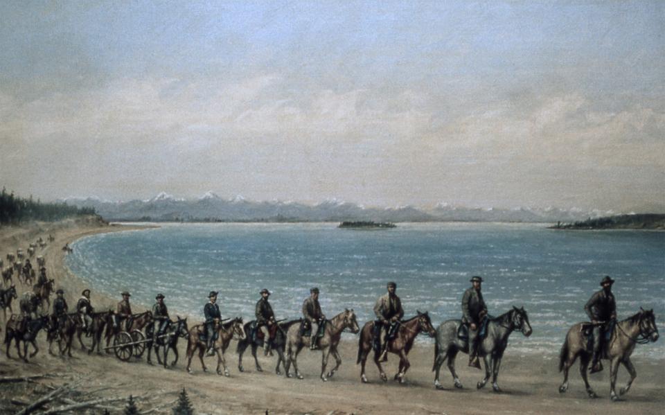 In the 1920s, after 60 years as a photographer, William Henry Jackson returned to painting. Working from memory and his own photos, he made this picture of the 1871 Hayden expedition on the march along the shore of Yellowstone Lake, with Stevenson Island in the background. National Park Service via Wikipedia.