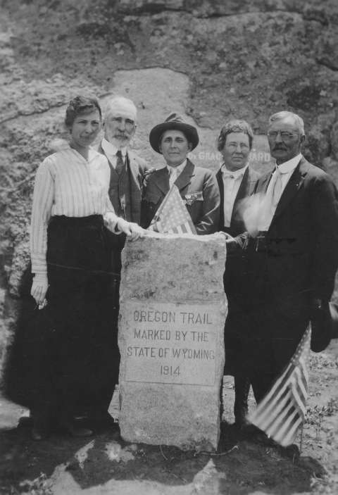 Affiliations of the people at a dedication of a new marker at Independence Rock July 4, 1920 show the mix of public and private efforts behind the early marking of Wyoming’s historic sites. Left to right, Mrs. Tom Cooper, Casper regent, D.A.R.;  Former Gov. B.B. Brooks; Grace Raymond Hebard, Oregon Trail Commission; Mrs. B.B. Brooks, state regent, D.A.R.; former frontiersman Fin Burnett. Many early Oregon Trail markers were inscribed with a 1914 date, but were erected and dedicated over a decade or more. American Heritage Center.