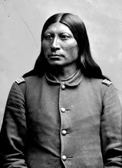 The Arapaho and their chief, Sharp Nose, shown here around 1880 in the uniform of an army scout, preferred cattle and rations in exchange for the land around the hot springs. American Heritage Center.