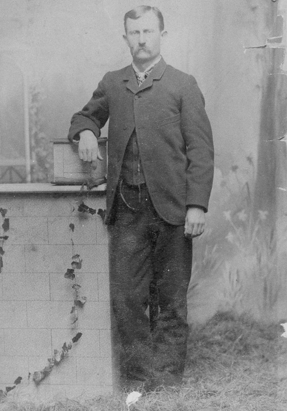 John A. Tisdale, shown here in the suit he was buried in. He was driving a wagon, loaded with groceries and Christmas toys for his children, home from Buffalo, Wyoming, to his ranch on the Red Fork of Powder River Dec. 1, 1891. In a gulch eight miles south of town, he was murdered from ambush. Johnson County Library photo.