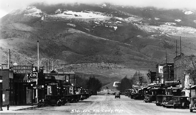 Looking west on Sheridan Avenue, Cody's main street, about 1930. On Rattlesnake Mountain beyond is the Cody High School C of whitewashed rocks, first placed by students in in 1927 and repainted annually by the senior class. (Author's collection.)