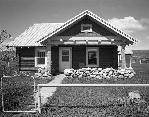 The house on the Huxtable/White Creek Ranch was built about 1934, with saddle-notched log walls on a stone foundation. Wyoming SHPO photo.