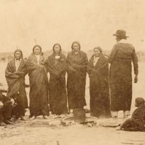 Sicangu (Brule) Lakota Sioux and Oohenonpa (Two Kettle) Lakota Sioux men and women and an interpreter gathered at Fort Laramie for the 1868 treaty signing. From left to right: Leon Palladay (interpreter), Fast Bear, Spotted Tail, White Eyes, Swift Bear, Whirlwind Soldier, Long Mandan, unidentified child, The Mule's wife, Big Partisan's daughter. Sherman collection of Gardner photographs; NMAI.