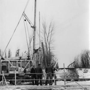 A drilling rig at the Hobo Hot Springs. The men stand above the stonework around the “Lobster Pot,” which remains unchanged today. Courtesy Saratoga Museum, P1986.59.37F.
