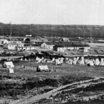 William Henry Jackson took this photo of Fort Laramie in 1870 during its peak years as an army post. Note the flagpole left of center and the two-story porch of Old Bedlam, the bachelor offiers' quarters, left of the flagpole. USGS photo library.