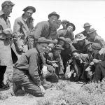 Young recruits to the Civilian Conservation Corps--the CCC-- start up a crap game shortly after arriving at the Encampment depot, 1933. Lora Nichols Collection, Grand Encampment Museum.