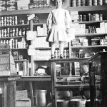 Ruth Parr stands on a store counter in Encampment, 1912. Lora Nichols Collection, Grand Encampment Museum.