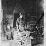 John Bastalich, who worked for the Union Pacific Coal Company for many years, in the blacksmith shop in Reliance, 1913. Sweetwater County Historical Museum photo.