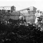A family garden in Reliance. In the background is the original wooden tipple, dating the photo between 1910 and 1936.  Sweetwater County Historical Museum.