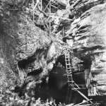 In the steepest parts of the canyon, the flume was perched on trestles or hung from steel cables anchored to eye bolts drilled into sheer rock walls. Wyoming State Archives.