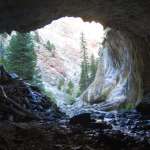 In the eastern part of the canyon, the flume negotiates two so-called natural bridges. In this one, the tunnel-like cavern is about 100 yards long. The flume since it was abandoned has become completely encased in travertine deposits on the west end. Eye bolts and steel cables used to suspend the flume are still visible on the walls. E. Rosenberg, 2010.