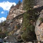 A short distance from the end of the canyon, the flume is elevated on stilts 20-30 feet above Warm Spring Creek on the north canyon wall. E. Rosenberg, 2010.