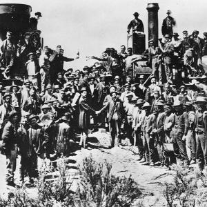 Celebrations for the driving of the Golden Spike at Promontory, Utah, May 10, 1868. The two men shaking hands at center are Samuel Montague, left, of the Central Pacific Railroad and Grenville Dodge of the Union Pacific. 
