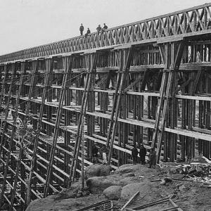 The Dale Creek trestle, 125 feet high and 1,400 feet long, brought the UP line down into Laramie after it came over the summit from Cheyenne. A.J. Russell, 1869. Wikipedia.