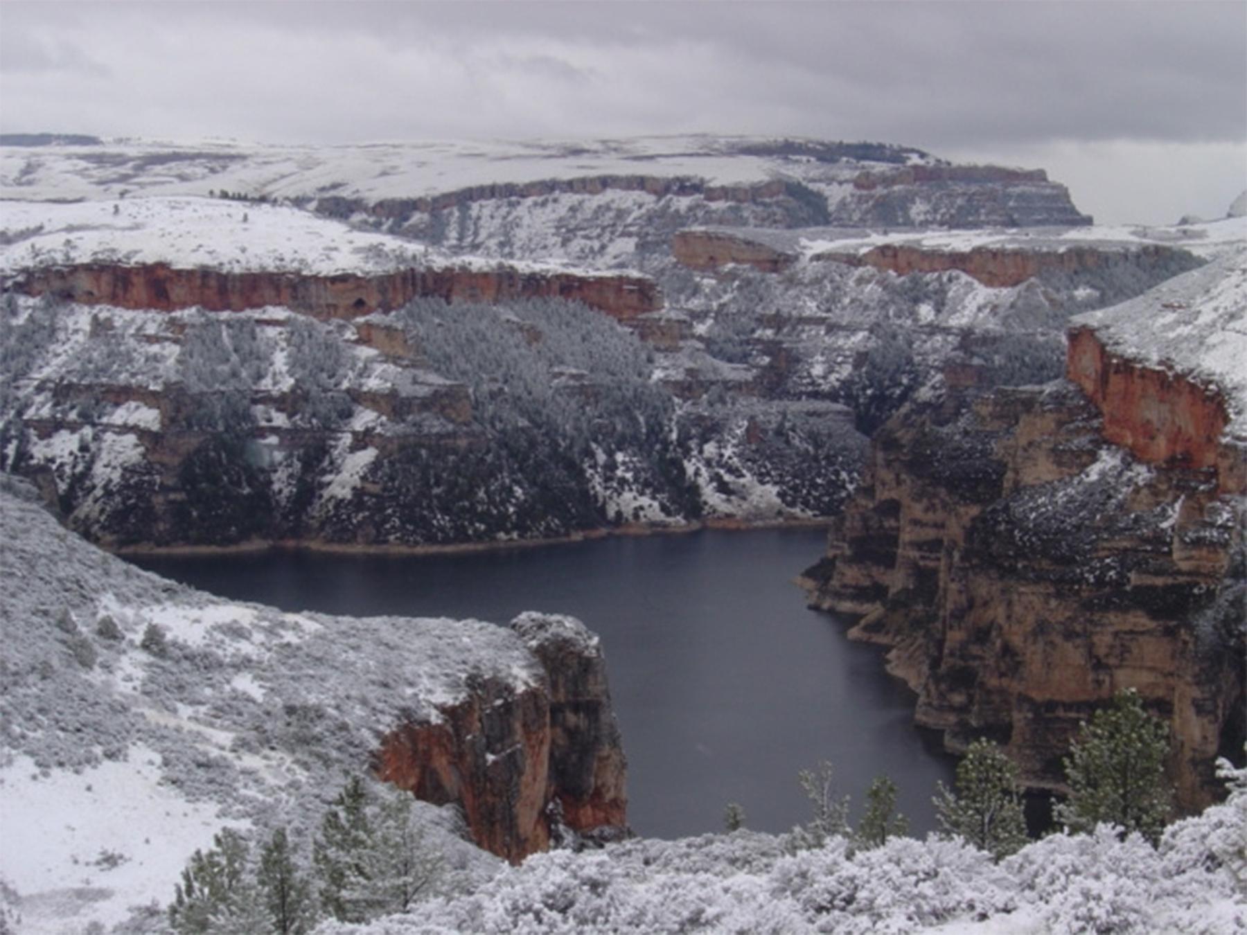 In March 1891, while awaiting permission to survey a route for the Burlington Railroad through the Crow Reservation in Montana, Gillette and a small crew decided to explore the canyon of the Bighorn River, shown here after a light snow. The canyon crosses the Wyoming-Montana border; its sheer cliffs rise in some places 2,500 feet above the water. In Gillete’s time the river, now dammed, was swift flowing and, when he explored the canyon, frozen—the men walked the length of the canyon on ice in below-zero t