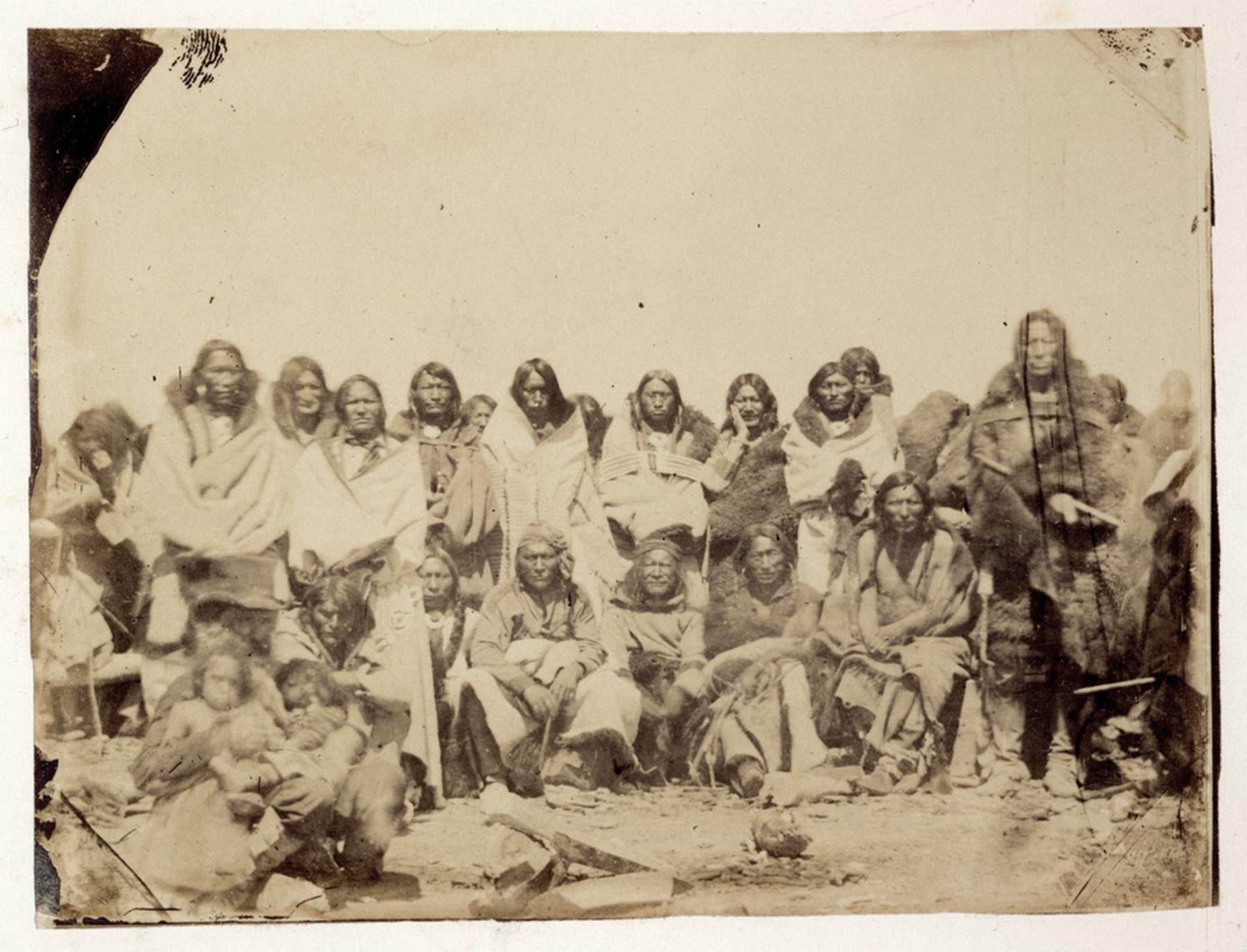 A group of Arapaho men and children, including Chief Friday, standing third from left. The white man in the top hat, seated at bottom left, may well be Maj. Thomas Twiss, U.S. agent to the tribes of the Upper Platte. If so, the two small children could be two of his three Lakota children, perhaps Charles and James, born about 1858. Photographed by James D. Hutton at Deer Creek, 1859. Blackmore Collection, British Museum.