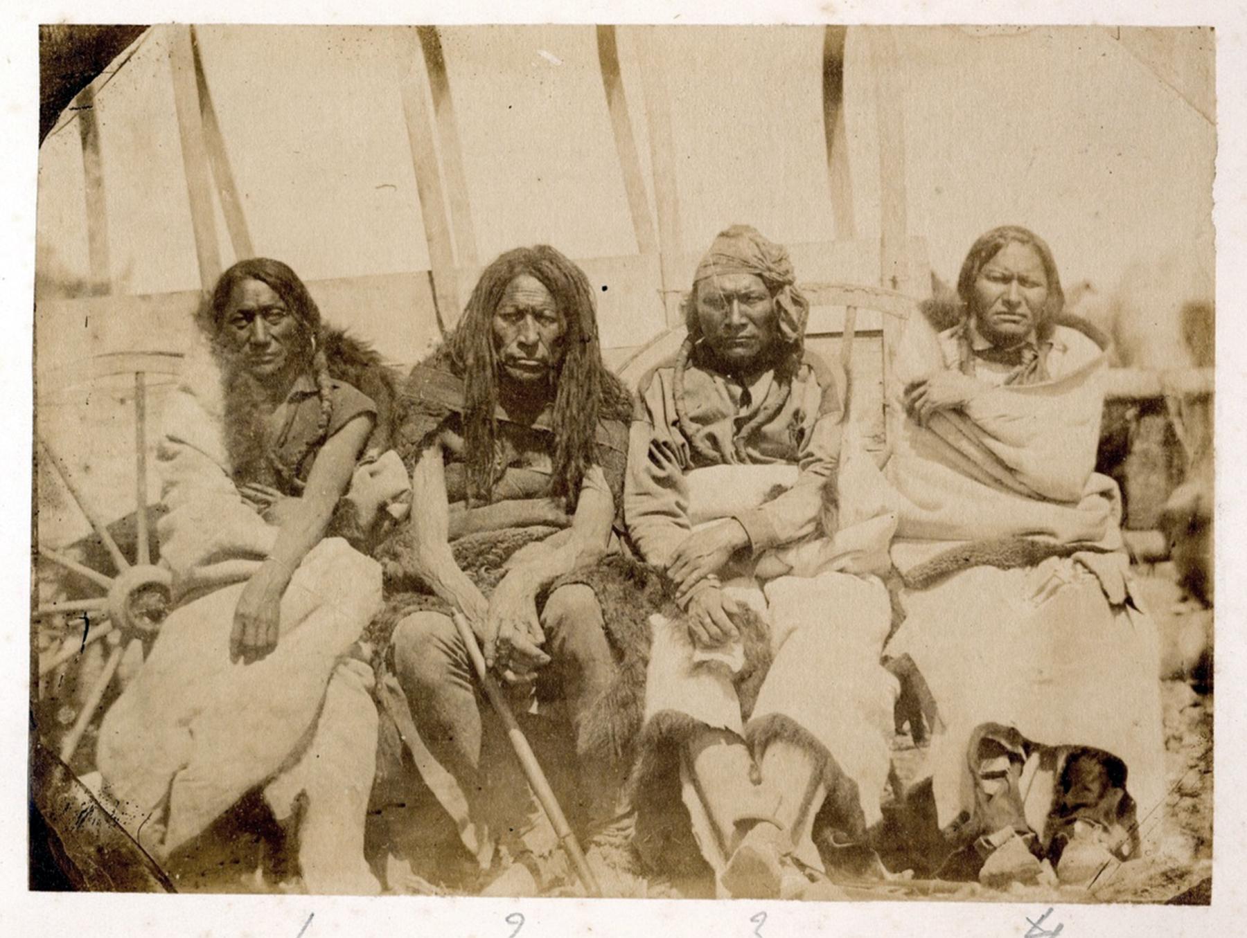 Four Arapaho leaders, left to right, Little Head, Split-nose, Little Owl and Friday, pose in front of a wagon at Deer Creek. Photographed by James D. Hutton, 1859. When Friday met Raynolds that fall, he told the captain there were messages waiting for him at Joseph Bissonette’s trading post on Deer Creek. Blackmore Collection, British Museum.