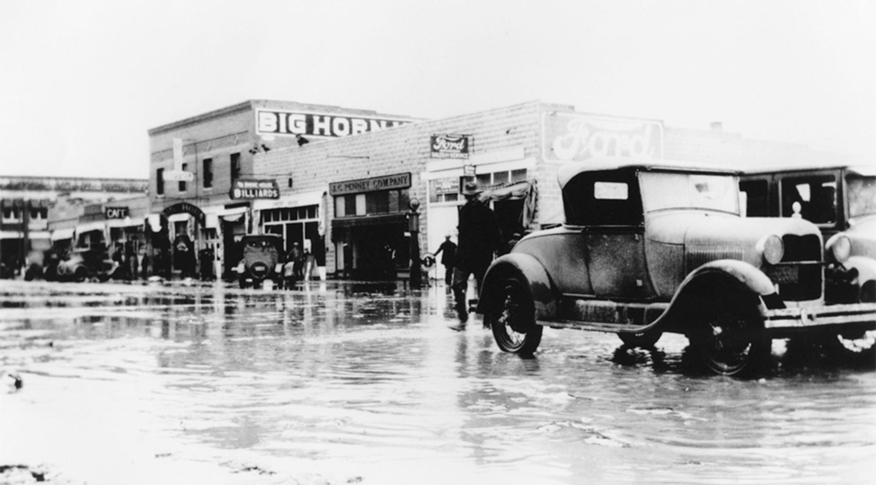 Floods in Greybull in the spring of 1929  left one child dead from a vehicle accident and at least 35 families destitute, destroying homes and businesses. Lizabeth Wiley raised funds and led relief efforts up to the end of her third and final term as mayor in 1930. Wyoming State Archives. 