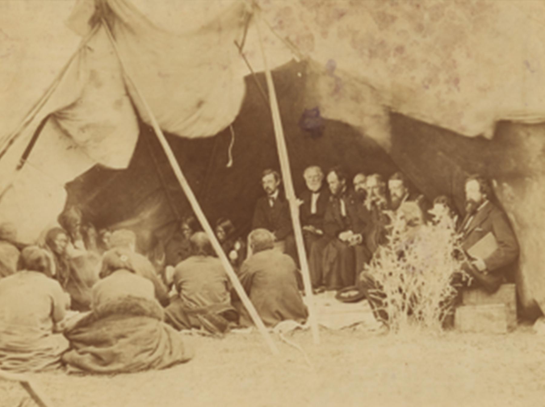 Indian Peace Commissioners in council with the Northern Cheyenne and Northern Arapaho at Fort Laramie, May 1868. The commissioners are, left to right: Col. Samuel F. Tappan, Gen. William S. Harney, Gen. William Tecumseh Sherman, John B. Sanborn, Gen. Christopher C. Augur, Gen. Alfred H. Terry, and Ashton S. H. White, commission secretary. This may be Gardner’s best-known image. William T. Sherman collection of Alexander Gardner photographs; National Museum of the American Indian (NMAI)Archive Center, Smiths