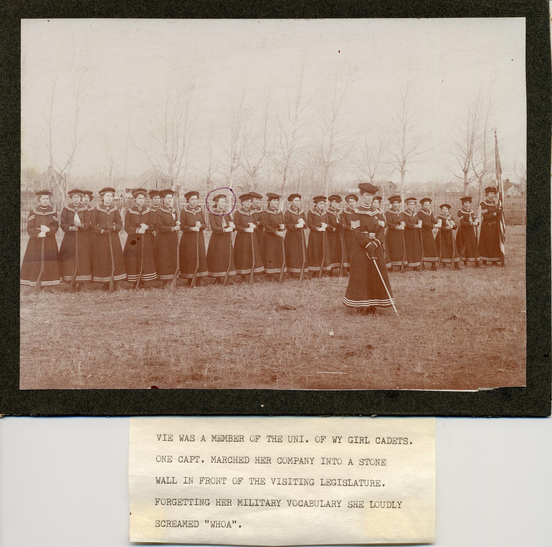 Vie, her face circled here, was a member of an all-female drill team while at the University of Wyoming in Laramie in the first years of the 20th century. The caption details one of the team's adventures. Garber family photo.