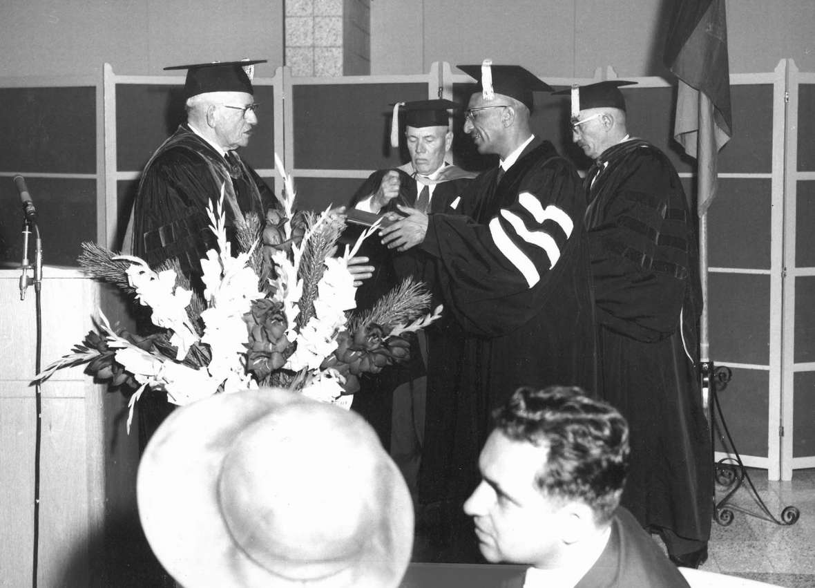 UW President Duke Humphrey confers an honorary doctor of laws degree on the king of Afghanistan. Standing, left to right, are Humphrey, College of Engineering Dean H. T. Person, King Zahir Shah, andGeology Professor Samuel H. Knight. American Heritage Center.