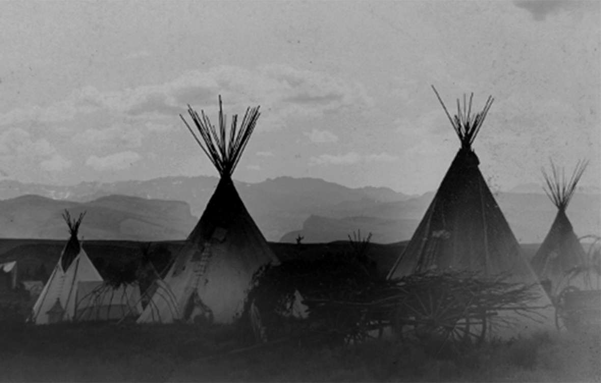 An undated photo of an Arapaho village on Little Wind River on the Shoshone Reservation. The mix of tents, tipis and wagons suggests the photo may be from the late 1800s. Wyoming State Archives.