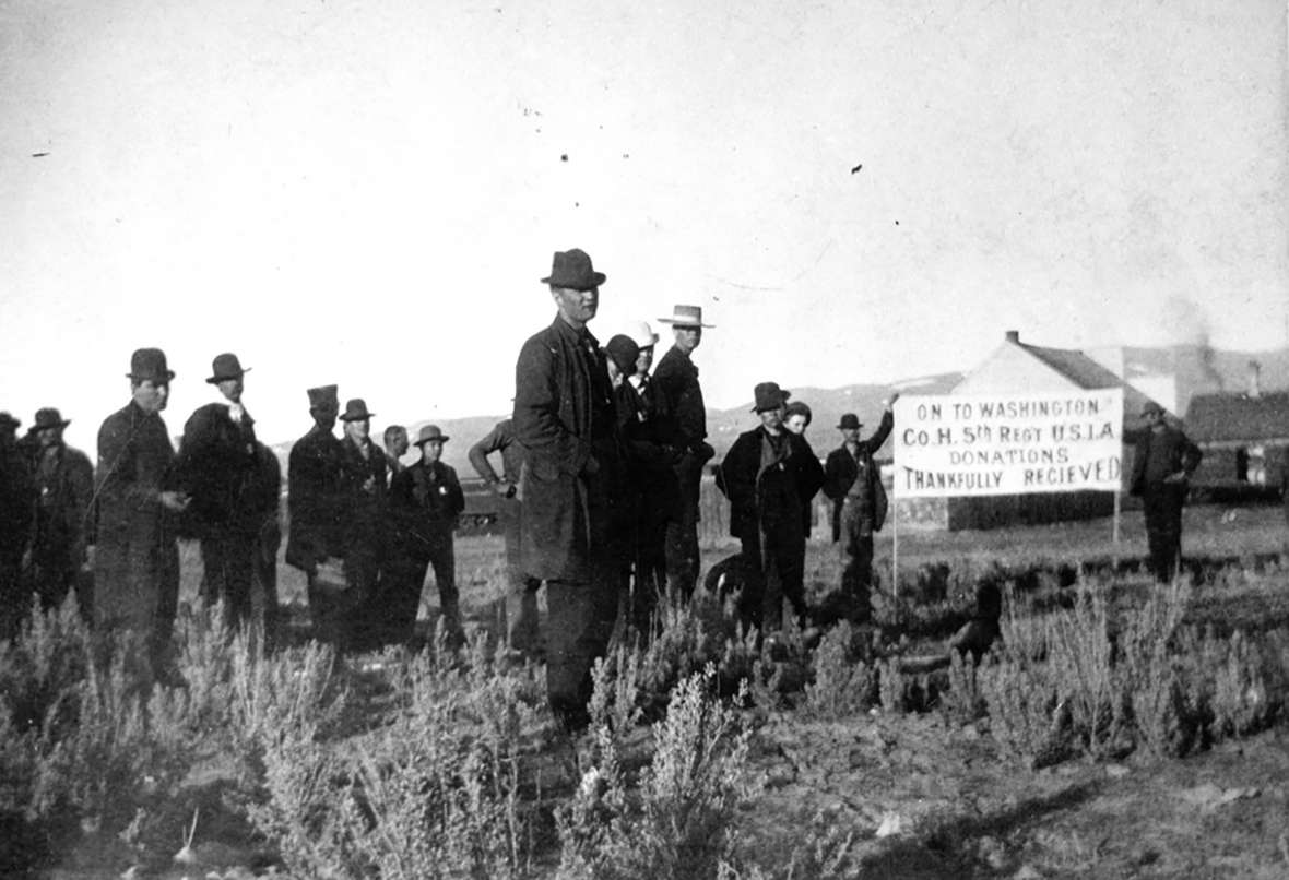 Another contingent of Coxeyites stole a train in Montpelier, Idaho, and were stopped at Green River Wyo., by U.S. Marshal Joe Rankin. Here, Coxeyite “Colonel” Shorty (in flat-crowned hat) and his “staff” shortly before their arrest May 15, 1894. The sign welcomes donations and announces the unit as Company H of the Fifth Regiment of the USIA—United States Industrial Army. Other photos show the colonel as a tall, thin man—the name may have been a nickname. Sweetwater County Historical Museum.