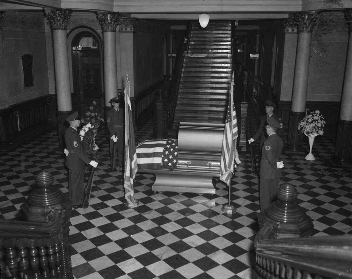 The body of U.S. Sen. Lester  Hunt lies in state in the rotunda of the Wyoming State Capitol, June 1954. Wyoming State Archives.