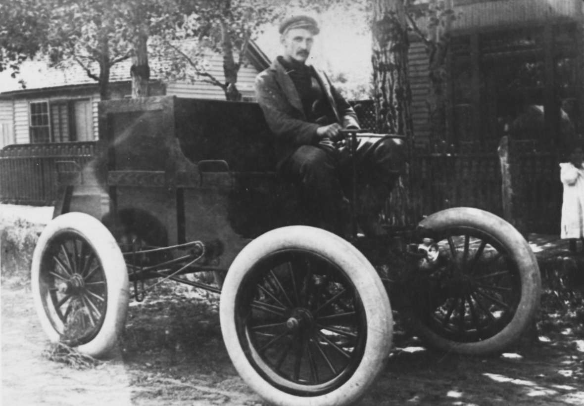 Laramie inventor and bicycle-shop owner Elmer Lovejoy in an undated photo of what may be his first automobile, which he built in 1898. Note the big tires—and what appears to be a chain drive. American Heritage Center.