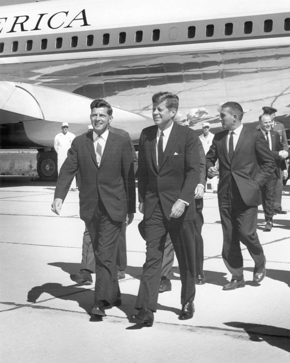Gale McGee, left, was still in his first Senate term when President Kennedy, center, stopped at the Cheyenne airport in October 1963. Behind the president is Interior Secretary Stewart Udall; behind him, shaking hands, is Cheyenne Mayor Bill Nation. Wyoming State Archives.