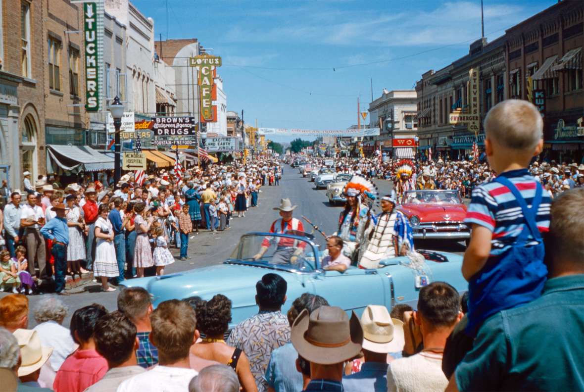 Spectators thronged the third annual All-American Indian Days parade in 1955, enjoying the floats, admiring Indian horses and regalia, and celebrating tribal veterans and the reigning Miss Indian America. Here, All American Indian Day founder Howard Sinclair rides in a convertible with honored Sioux guests. Courtesy David Eppen.