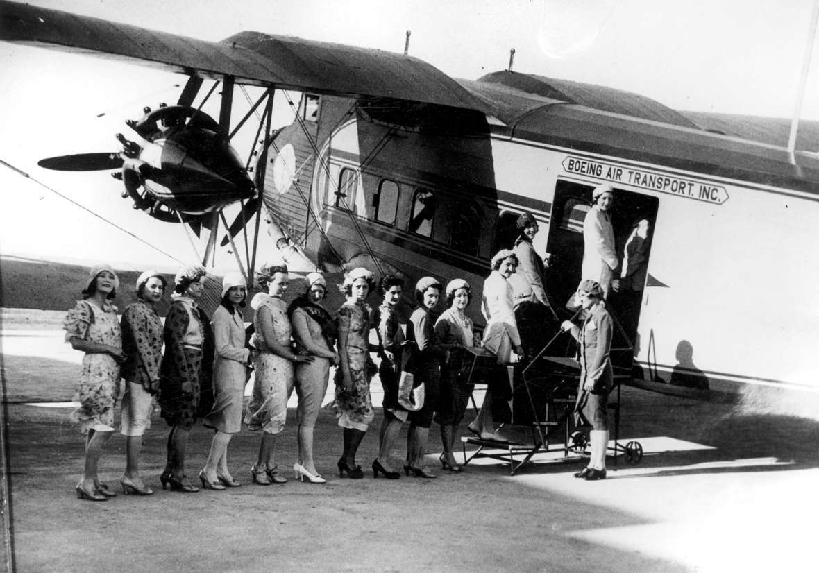 On a windy day in 1930s Cheyenne, newly recruited Boeing Air Transport stewardesses (all of them unidentified) line up to board a flight on a Boeing Model 80A aircraft. Wyoming State Archives. On a windy day in 1930s Cheyenne, newly recruited Boeing Air Transport stewardesses (all of them unidentified) line up to board a flight on a Boeing Model 80A aircraft. Wyoming State Archives.