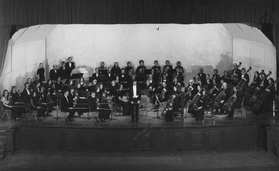 The Casper Symphony Orchestra, spring 1974, on the stage of the Natrona County High School auditorium in Casper shortly after Curtis Peacock, center, took over as music director. WSO archives. The Casper Symphony Orchestra, spring 1974, on the stage of the Natrona County High School auditorium in Casper shortly after Curtis Peacock, center, took over as music director. WSO archives.