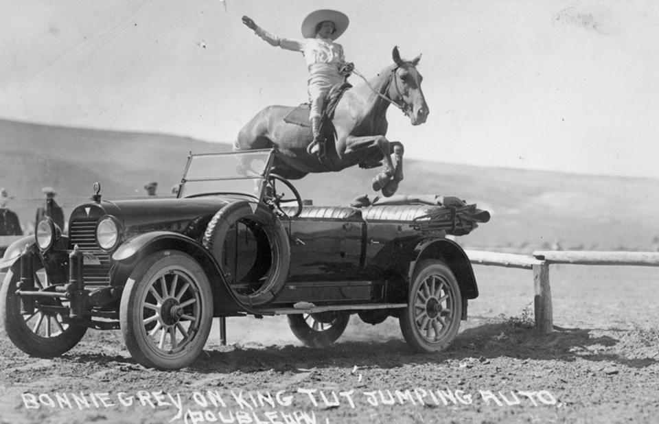 Bonnie Gray, on King Tut, jumps a car in Wyoming in the mid 1920s. Wyoming State Archives.