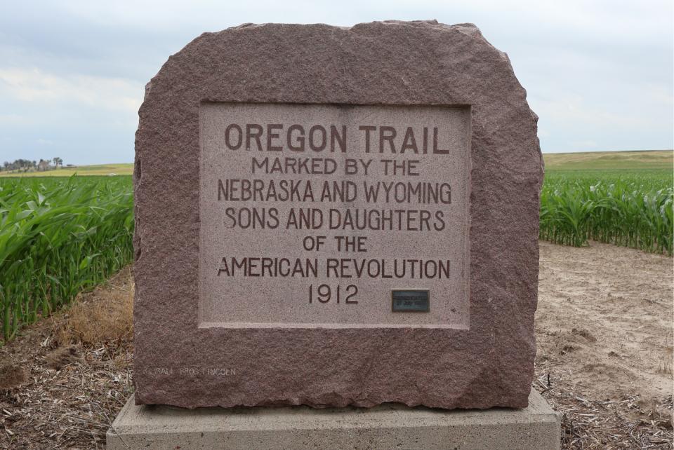 This red granite monument, marking an Oregon Trail location, was placed  on private property on the Nebraska-Wyoming border near Scottsbluff in  1912. The Nebraska and Wyoming Sons and Daughters of the American  Revolution plus the Nebraska State Oregon Trail Memorial Commission  spearheaded the effort. Photo by Kylie Louise McKormick. 