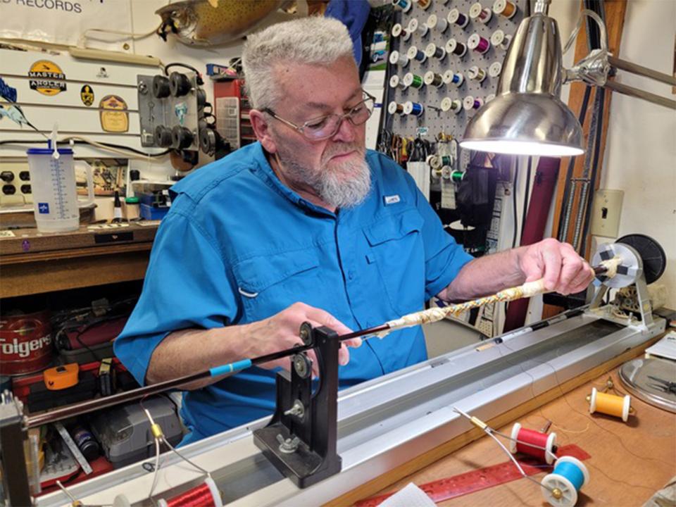 Mark Lambert wraps a custom rod highlighting a Native American fishing guide's dancing regalia colors. Author photo.