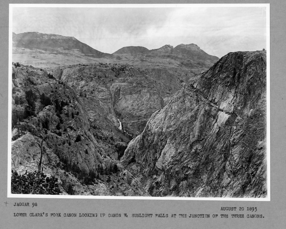 black and white photo of rocky canyon with higher peaks in the distance