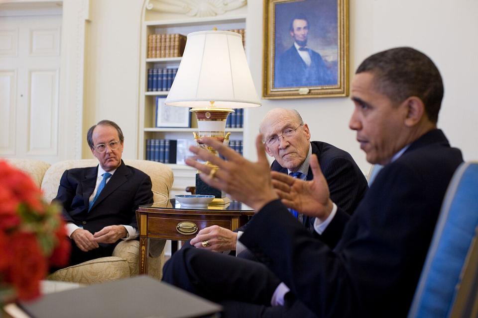 Alan Simpson looks at President Barack Obama during a meeting in the Oval Office