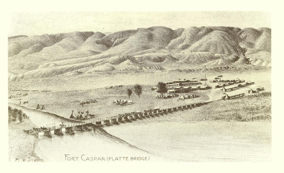 distant view of wooden bridge across a river, leading to an area of sparse low buildings with rounded hills in the distance