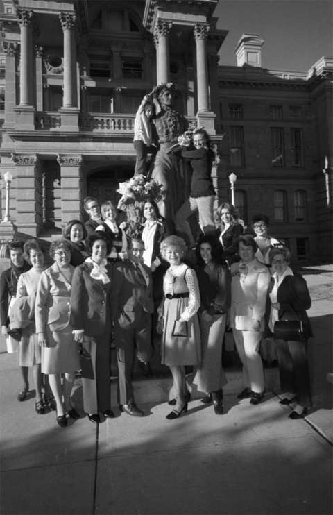 The day the measure was ratified, happy ERA supporters decked the statue of women’s rights icon Esther Hobart Morris at the Wyoming Capitol with flowers. Julia Yelvington stands just to the right of the statue. At bottom, front row, second from left is Wavis Twyford of Cheyenne, fourth from left is Mako Miller of Casper and fifth from left is Sen. David Hitchcock, Democrat of Albany County; Secretary of State Thyra Thompson is front and center. In the second row, far left is Sheila Arnold of Laramie, later a representative from Albany County. Brammar photo, Wyoming State Archives.