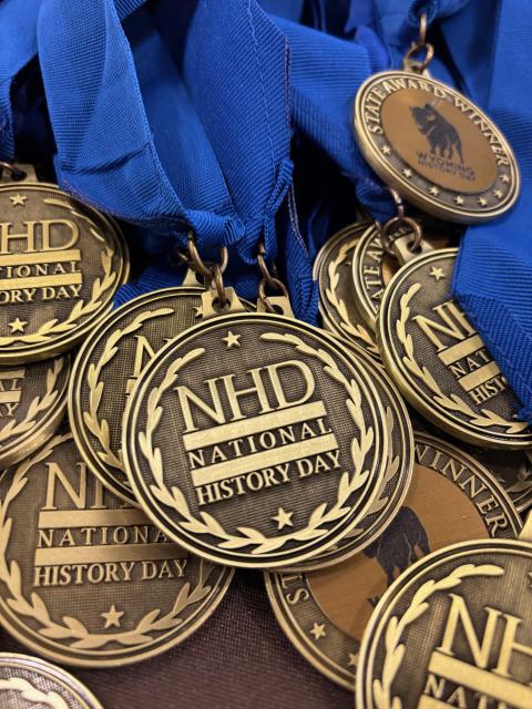 Winner's medals for the 2025 Wyoming History Day Medals inscribed with "NHD / National History Day" on one side; "State Award Winner / Wyoming History Day" on the other
