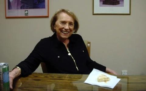 Kathy Karpan Kathy Karpan smiling and sitting at a table