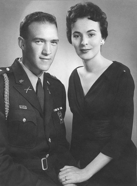 Formal portrait of Alan Simpson in military uniform withe Ann Schroll om a a dark dress 