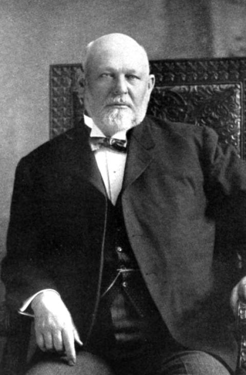 1915 portrait of Joseph Carey, posed in a chair.